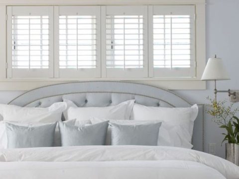 interior bedroom shutters in a white bedroom