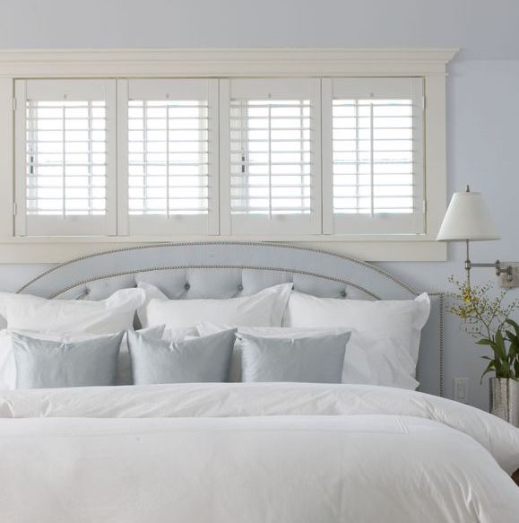 interior bedroom shutters in a white bedroom