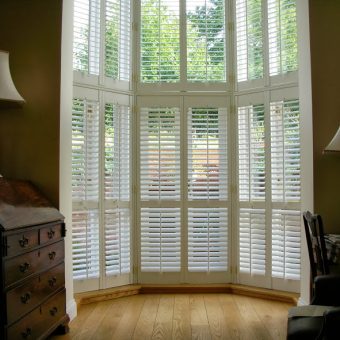 interior shutters in large window in atrium