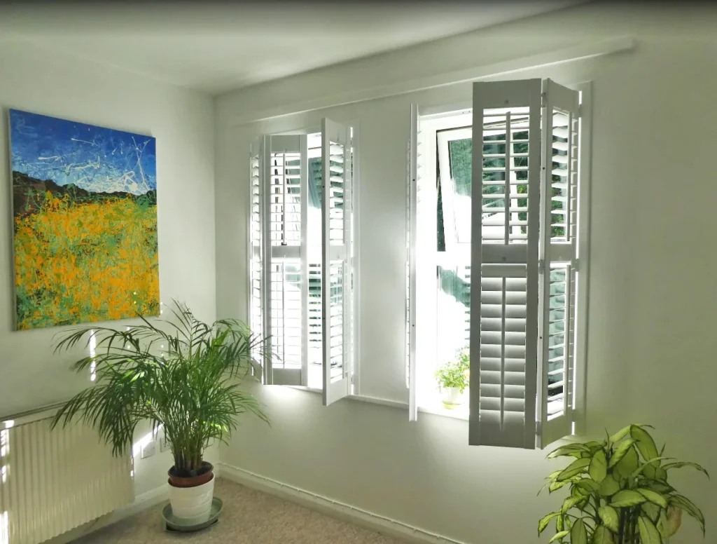 bespoke solution using CraftWood shutters in Pure White with 64 mm louvres and centre tilt rods